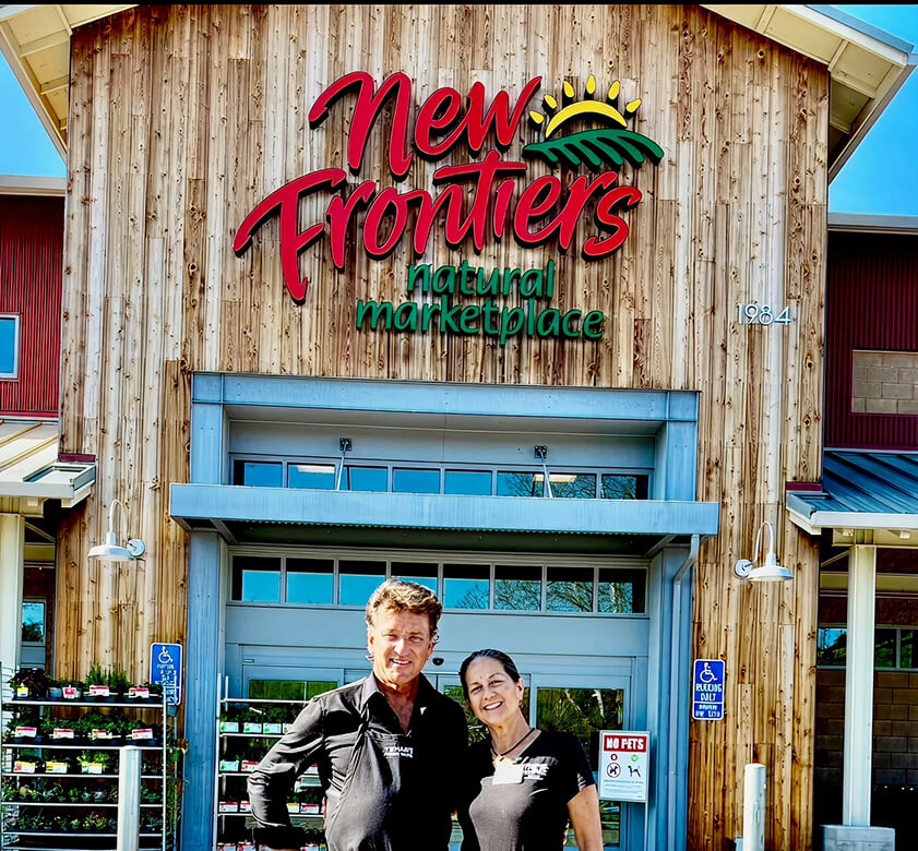 Owner, John in front of New Frontiers Natural Marketplace