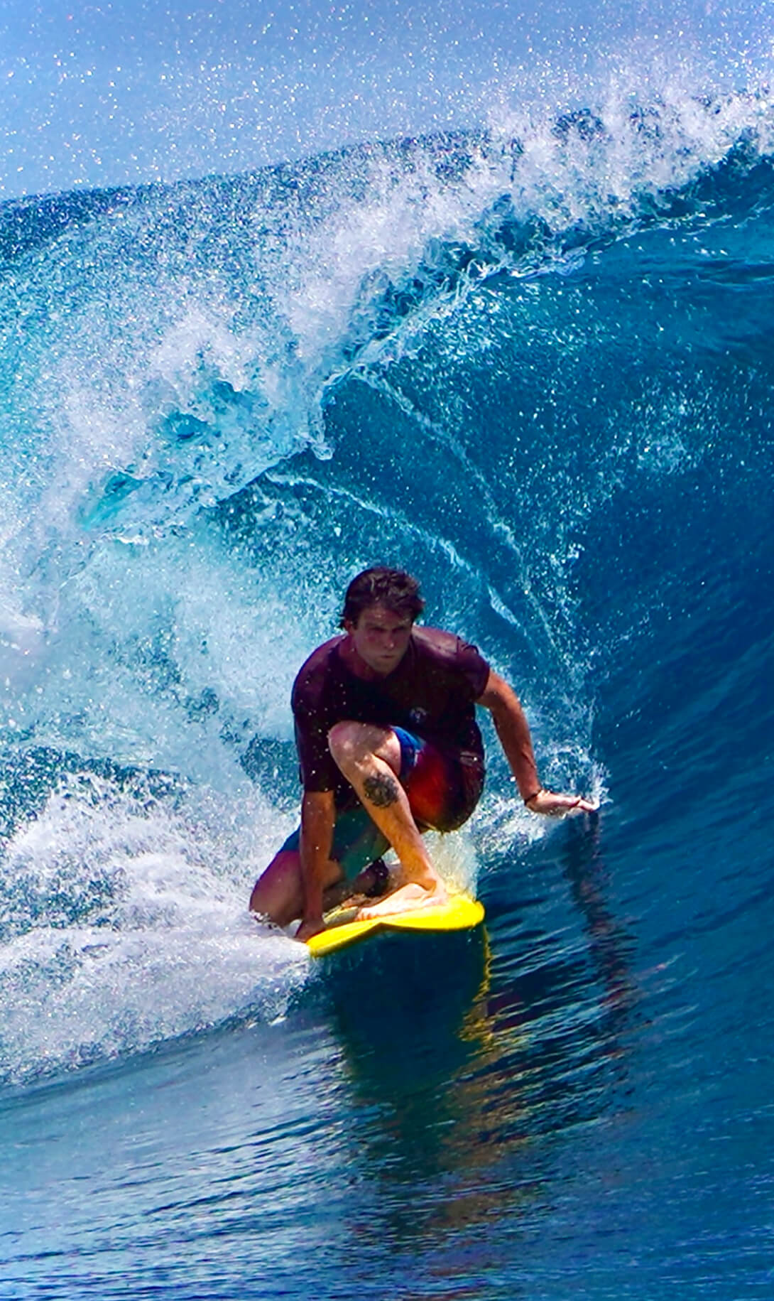 Active athlete surfing a wave, a Tieman's Fusion Coffee customer testimonial about steady performance energy