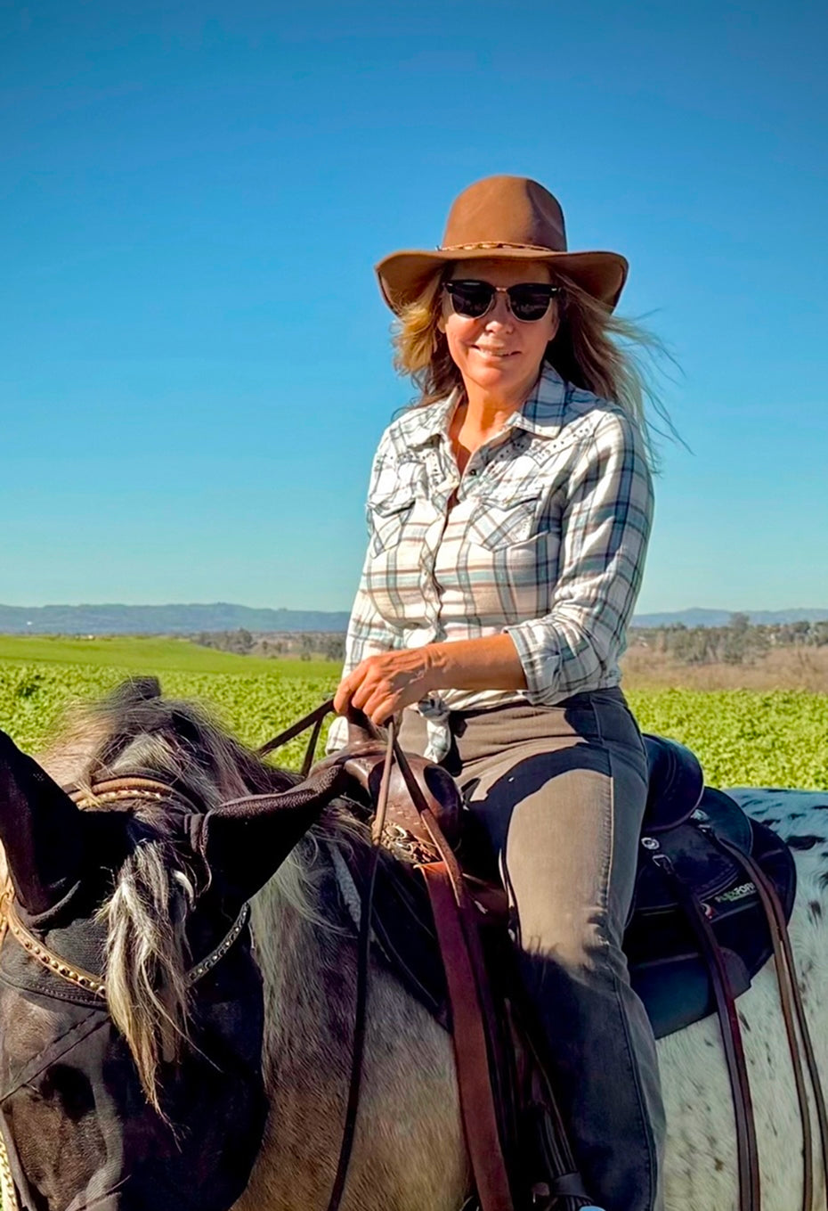 Tieman's Fusion Coffee co-founder smiling outdoors in a sunny green field
