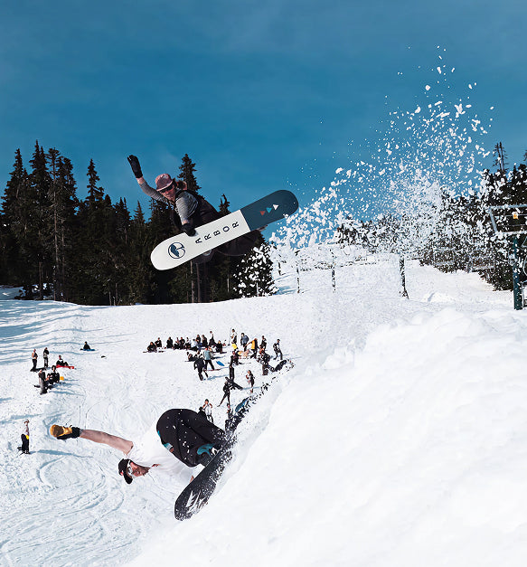 Snowboarder launching off a snowy slope, fueled by Tieman's Fusion Coffee low acid performance coffee for steady energy